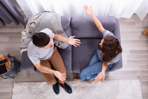 Image representing a Boulder couple on couch having an animated discussion